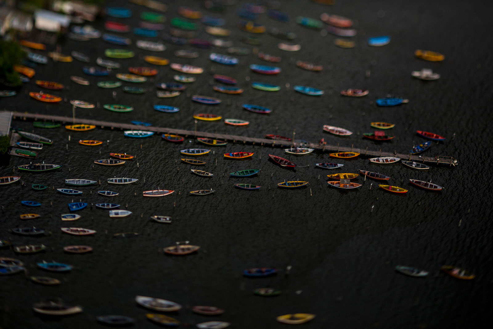 Fishing boats float in this photo taken with a tilt-shift lens in Rio de Janeiro, Brazil, on Wednesday, May 20, 2015.
