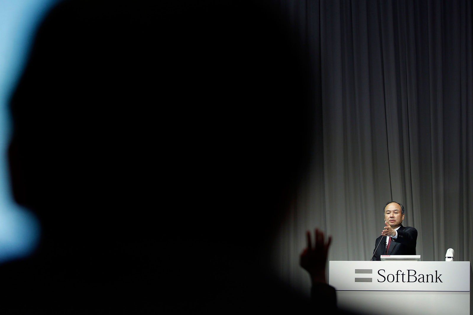 Billionaire Masayoshi Son, chairman and chief executive officer of SoftBank, points to a journalist during a news conference in Tokyo