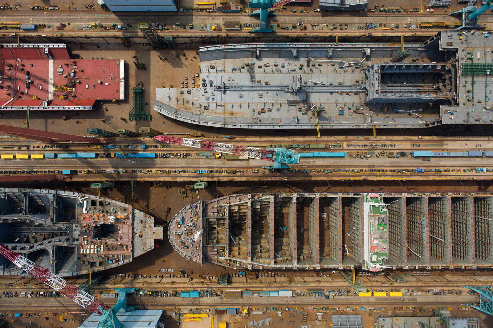 Ships stand under construction in this aerial photograph taken above the Hyundai Heavy Industries shipyard in Ulsan, South Korea