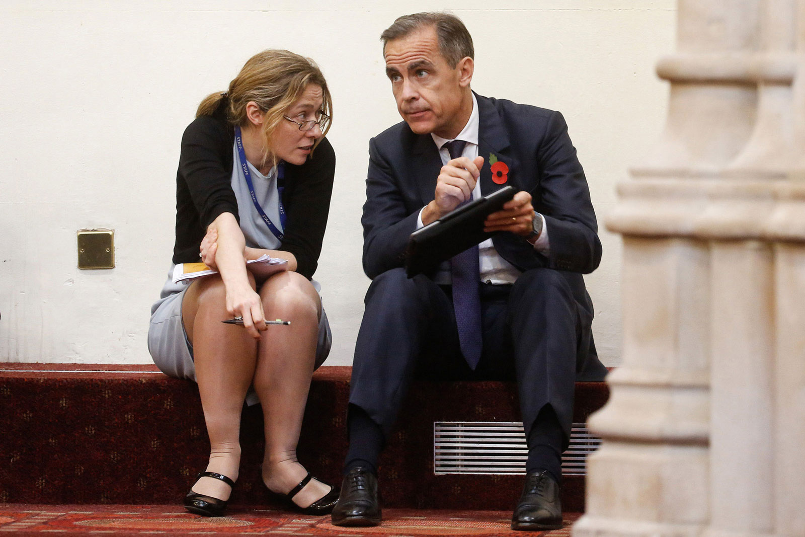 Mark Carney, governor of the Bank of England, speaks with a colleague at the Bank of England Open Forum at the Guildhall in London