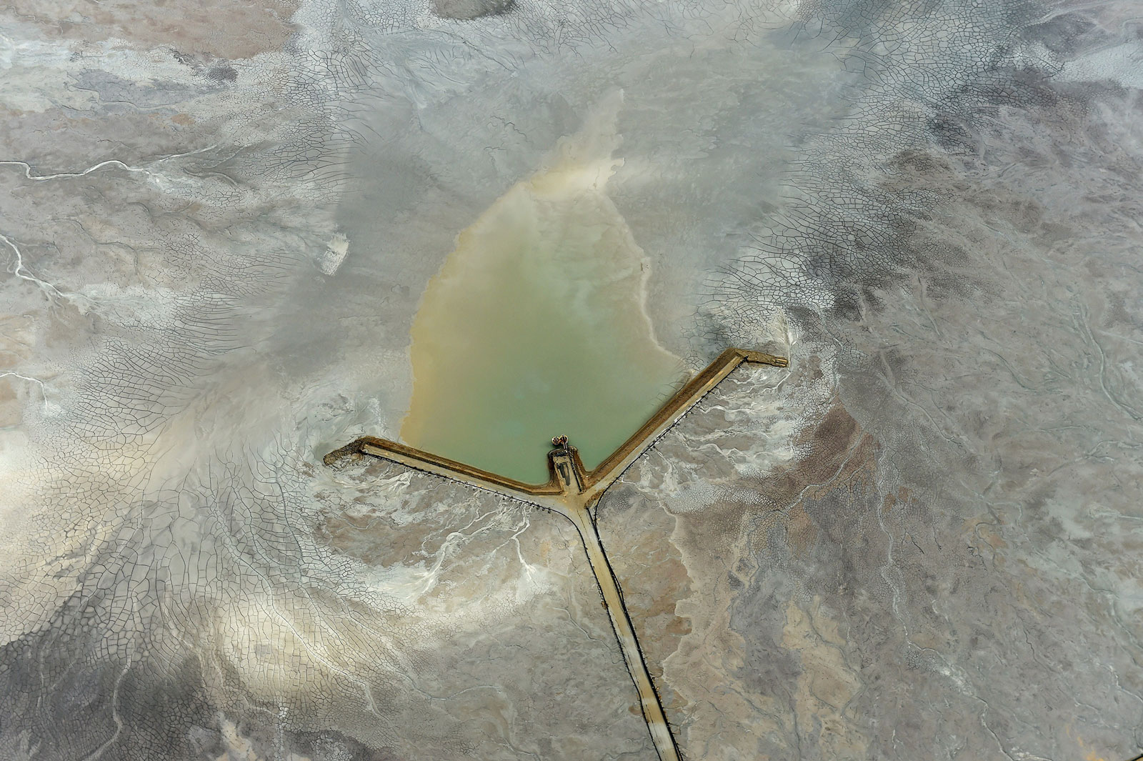 A road leads to the center of a tailings dam at the Fimiston Open Pit mine, in Kalgoorlie, Australia
