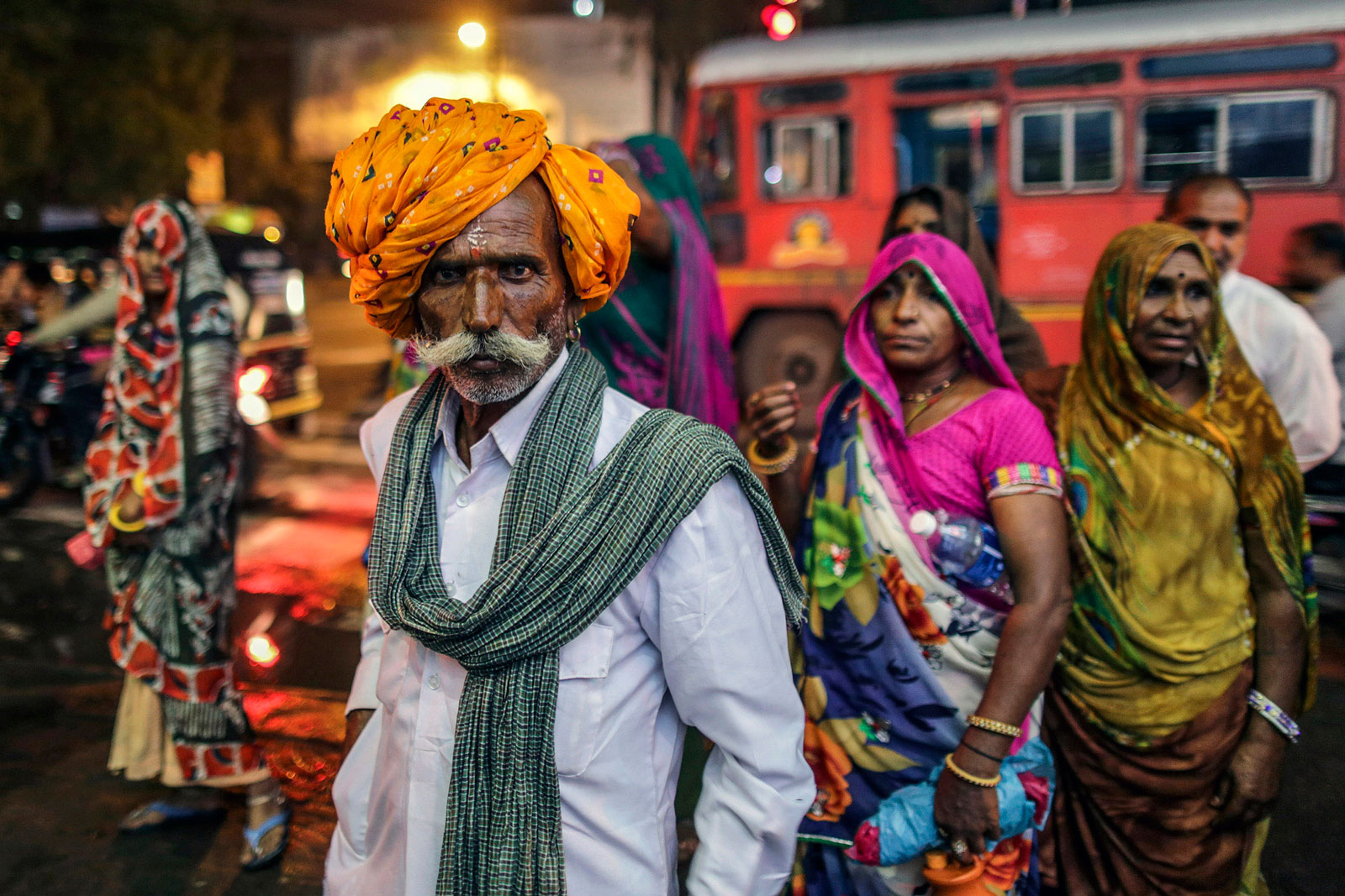 A Hindu pilgrim poses for a photograph near a bus stop in Nashik, Maharashtra, India