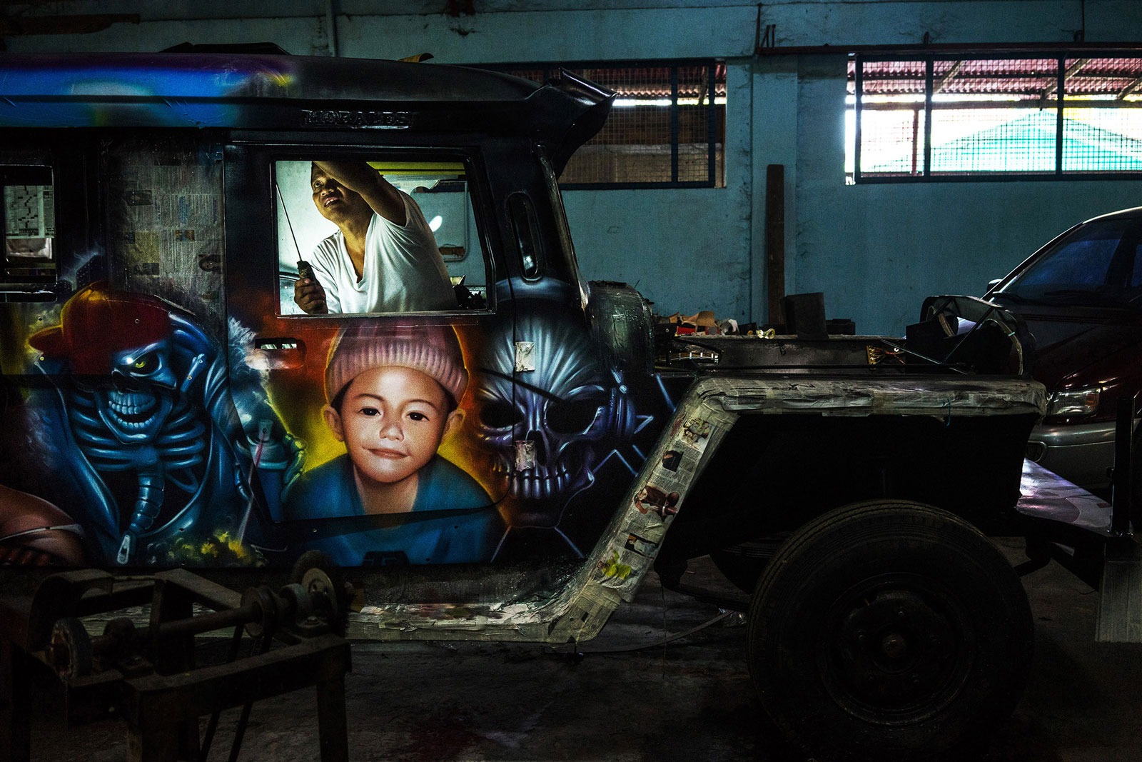 A mechanic works on the interior of a jeepney at the Morales Motors workshop in San Mateo, Rizal Province, the Philippines