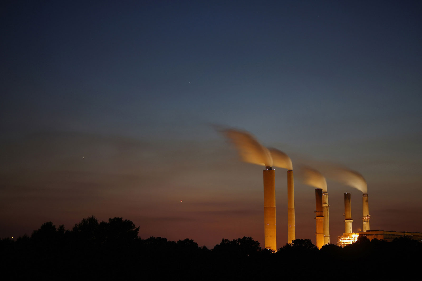 Emissions rise from stacks at the Duke Energy Gibson Station power plant at dusk in Owensville, Ind., U.S.