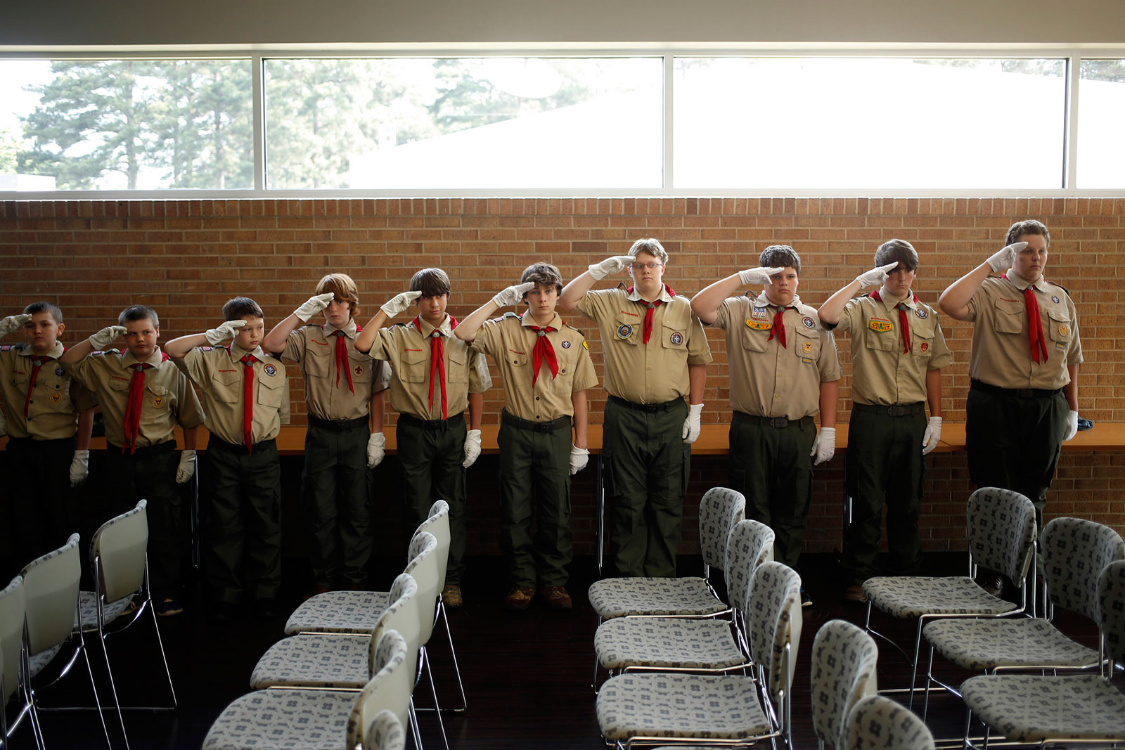 Boy Scouts from Troop 5 practice saluting at an event at Hempstead Hall in Hope, Ark.