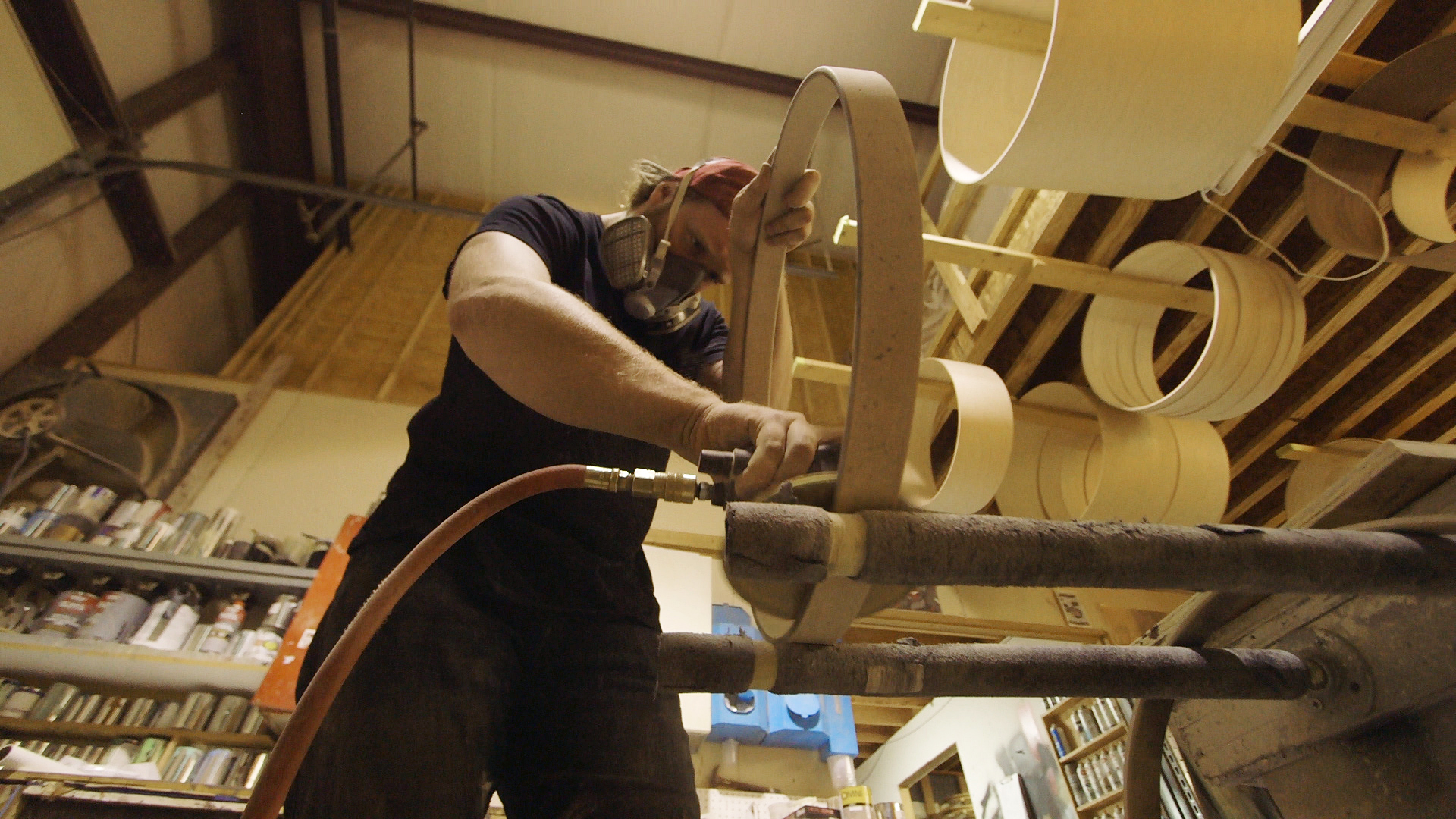 A band saw frees the individual skis from the <em>raw block</em> of sandwiched-together materials.