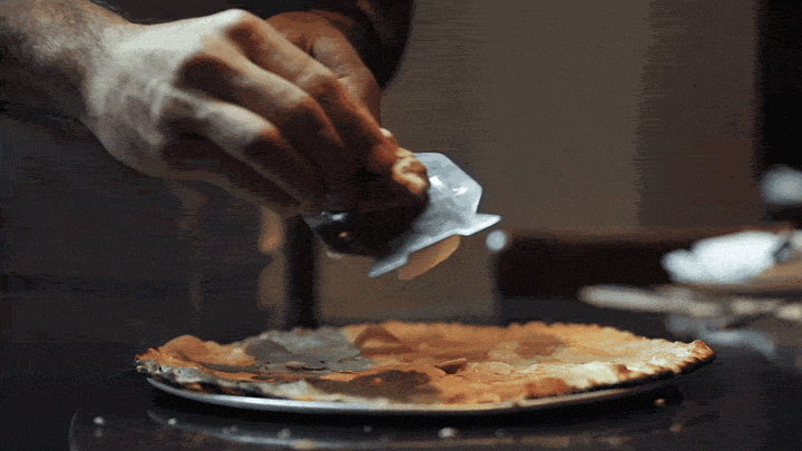 adding ingredients to a pizza