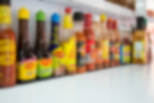 Various sauces and salsas lined up along the front counter at El Rey de Pavo